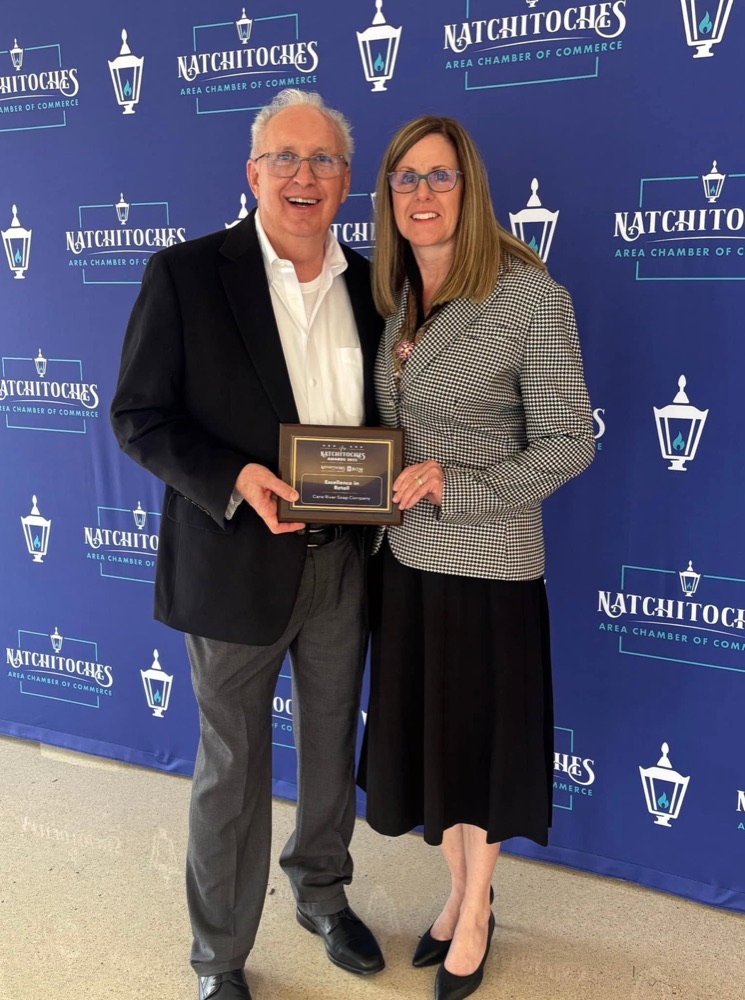 Mike and Kim Walthall accepting the Excellence in Retail award for Cane River Soap Company at the Natchitoches Area Chamber of Commerce awards